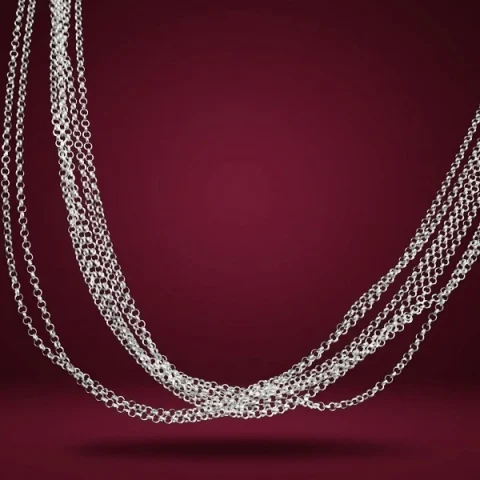 Cadena plata ley 925 estilo rolo con acabado pulido sobre fondo elegante de terciopelo borgoña.